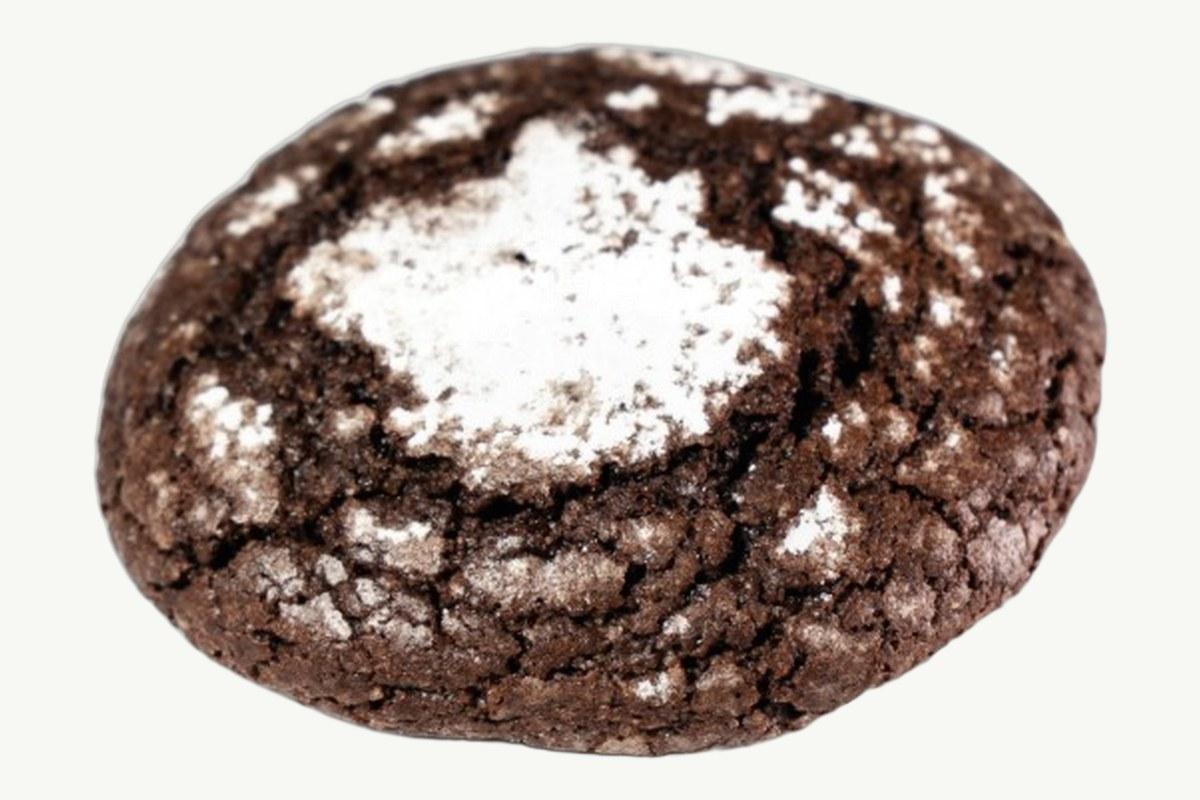 Chocolate crinkle cookie with a cracked sugar crust on a plain cream background