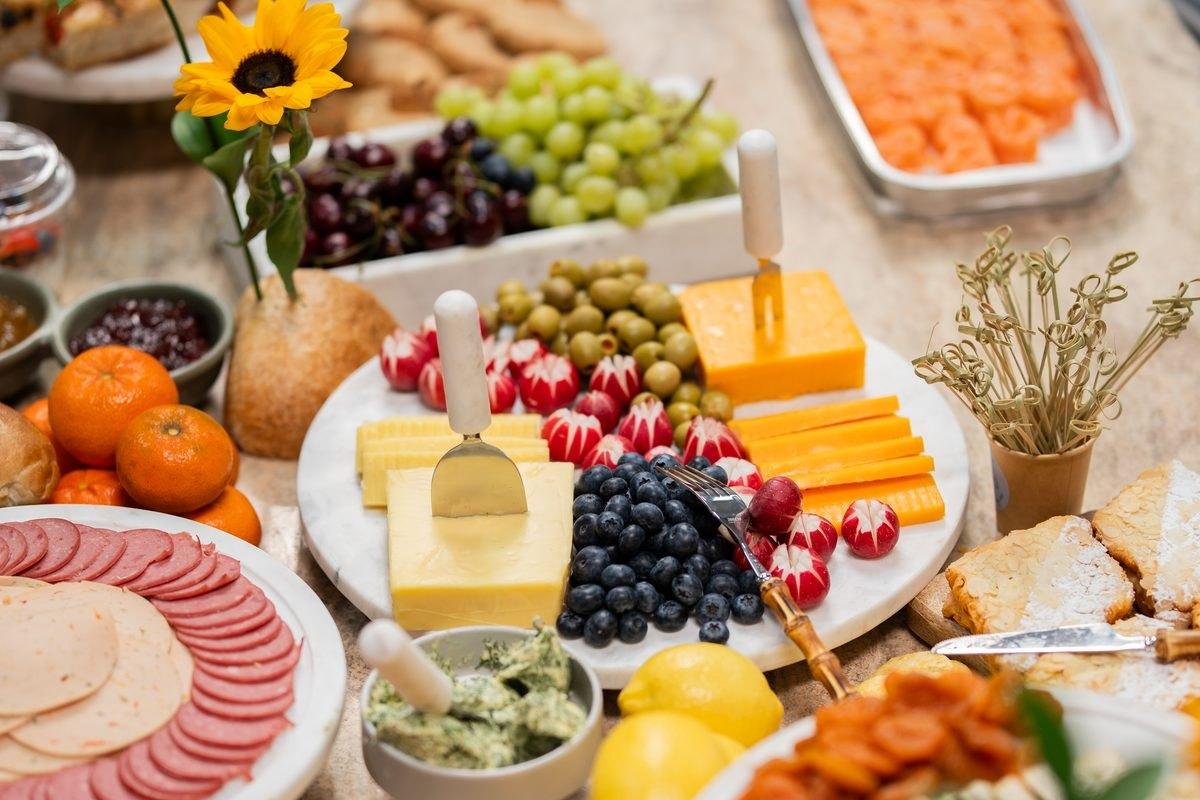 Grazing table with cheese, fruit, cured meats and bread laid out for an event