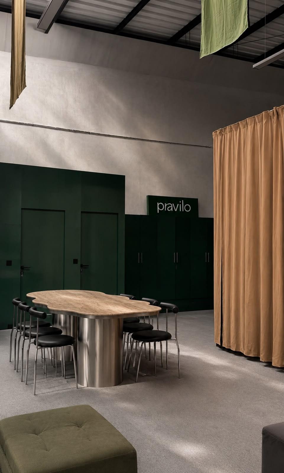 The long table where breakfast is served, in front of the green lockers