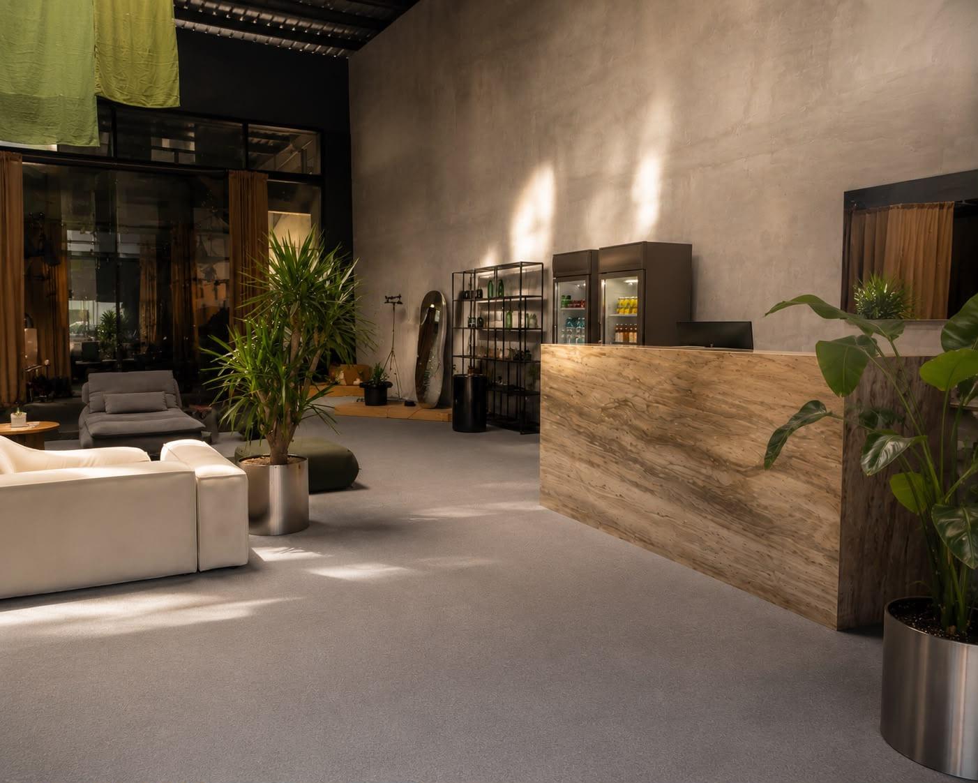 Pravilo's reception — a stone counter, low sofas and afternoon light on the walls