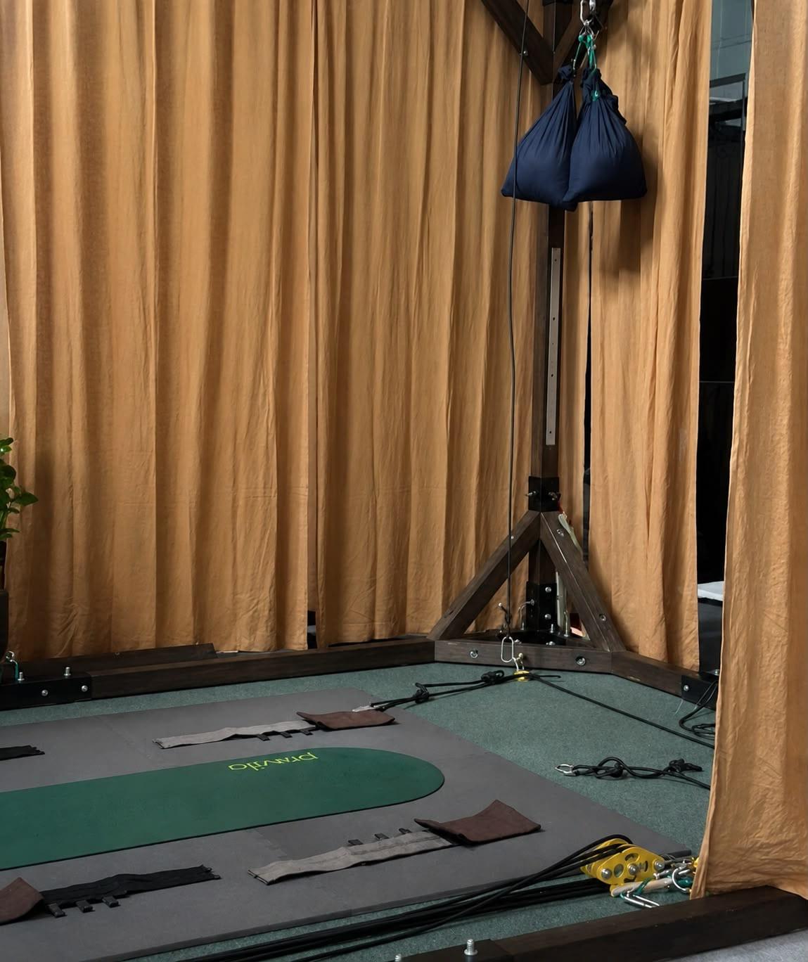 A quiet corner of the studio behind ochre linen curtains